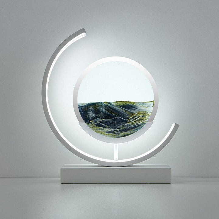 "3D Sand Shell Table Lamp emitting soothing green LED light; modern art-inspired design with dynamic sand patterns."