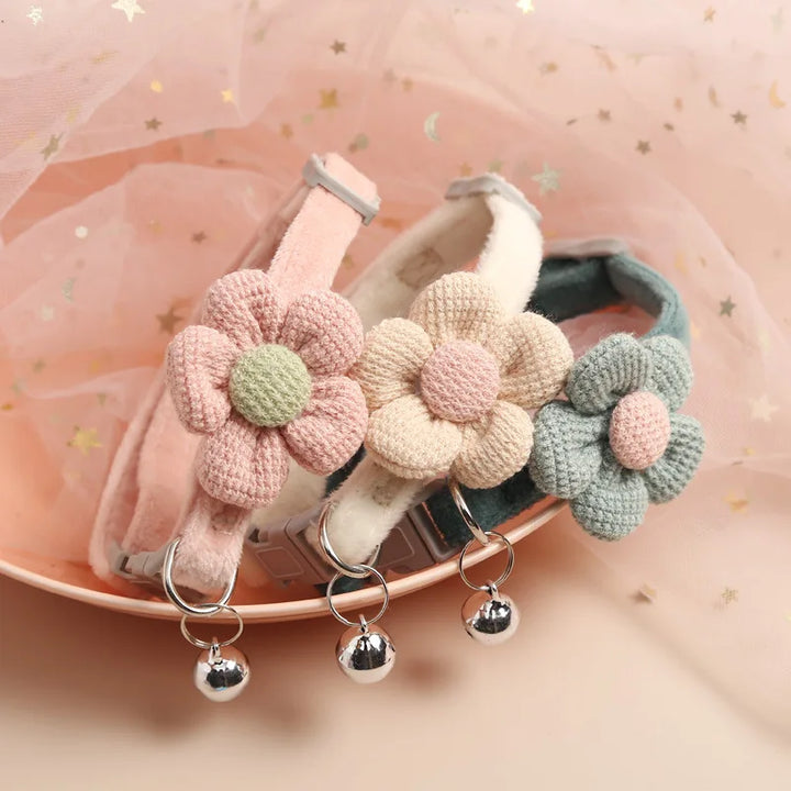 "Adjustable cat collar with floral pattern and bell, featuring earth tones and pastels for style and comfort."