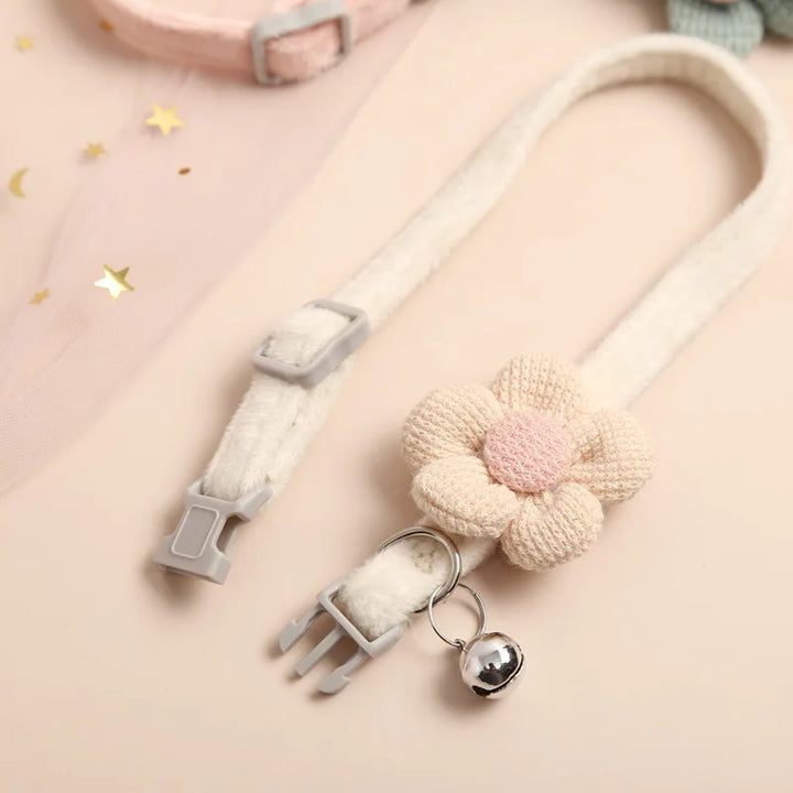 "Adjustable cat collar with floral pattern and bell, featuring earth tones and pastels for style and comfort."