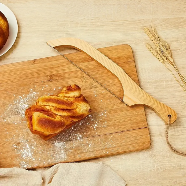 "Bamboo-handled stainless steel bread bow cutter, elegant design, perfect for slicing fresh bread with precision and style."