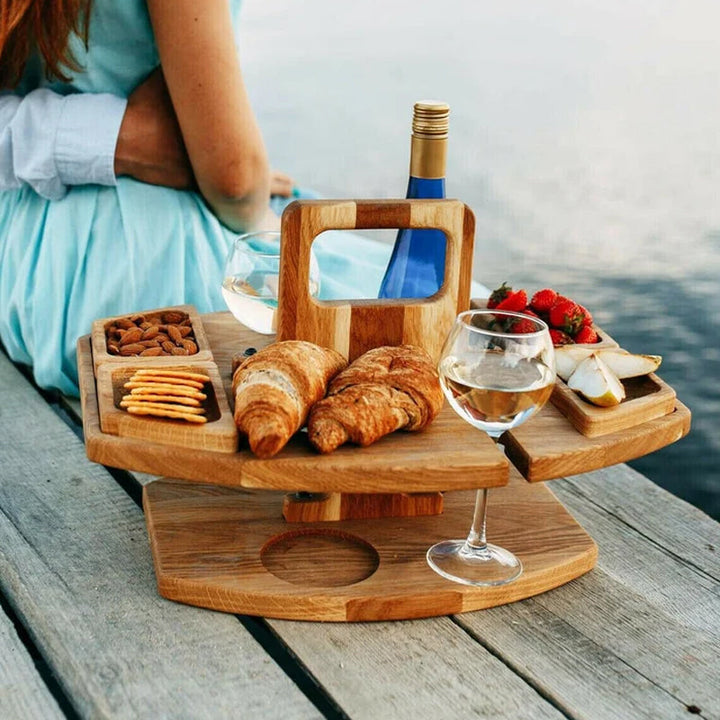 Compact wooden picnic wine table with compartments for snacks and wine, featuring a foldable, elegant design for outdoor gath