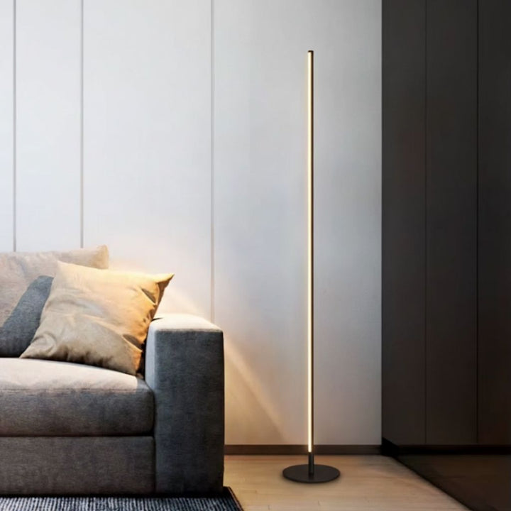 Elegant LED floor lamp with adjustable soft glow, minimalist design in aluminum and acrylic, ideal for modern living rooms.