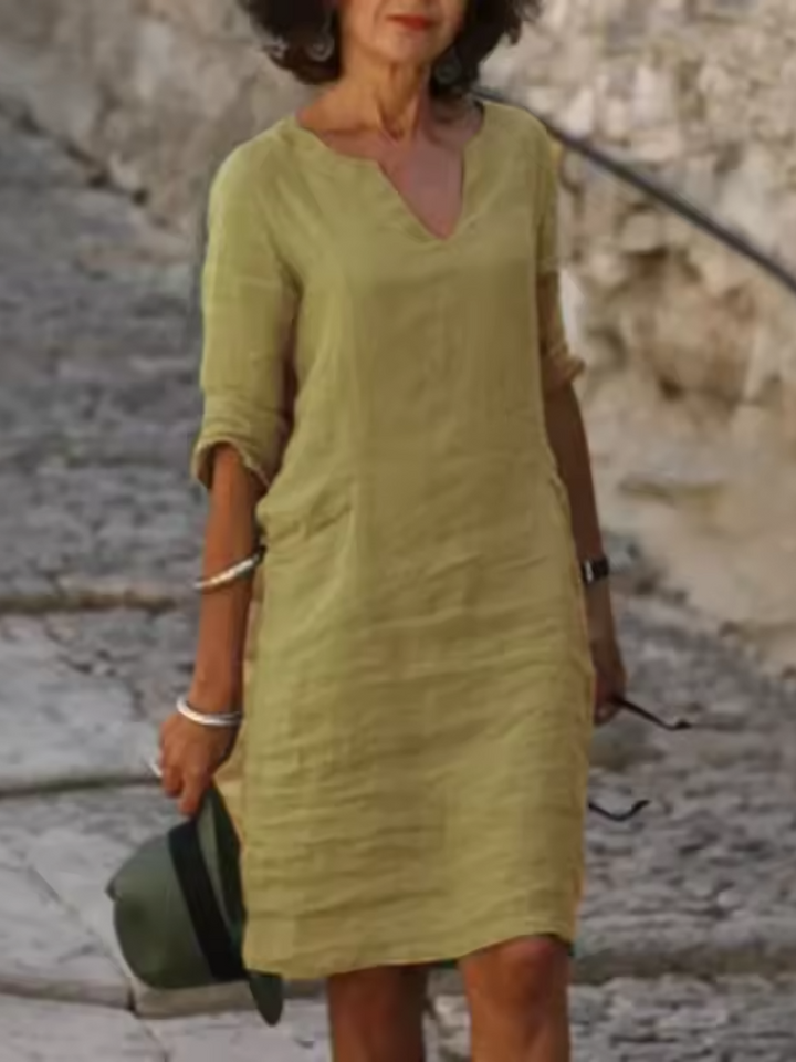 Elegant slim fit V-neck cotton linen dress with mid sleeves, perfect for warm weather. Shop women's dresses for all occasions