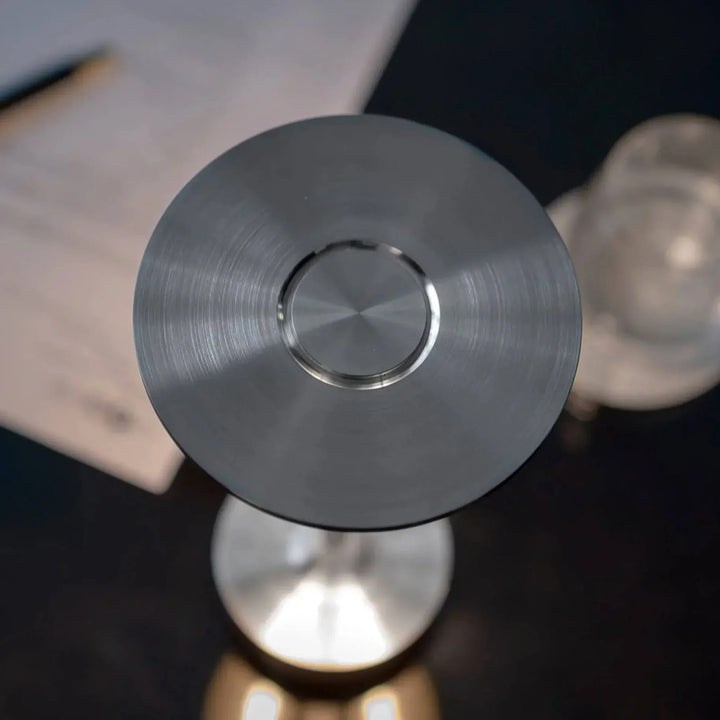 "Elegant wireless table lamp with sleek curves, gold finish; perfect for versatile ambient lighting on any table or desk."