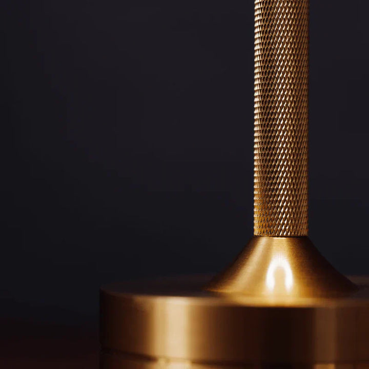 "Elegant wireless table lamp with sleek curves, gold finish; perfect for versatile ambient lighting on any table or desk."