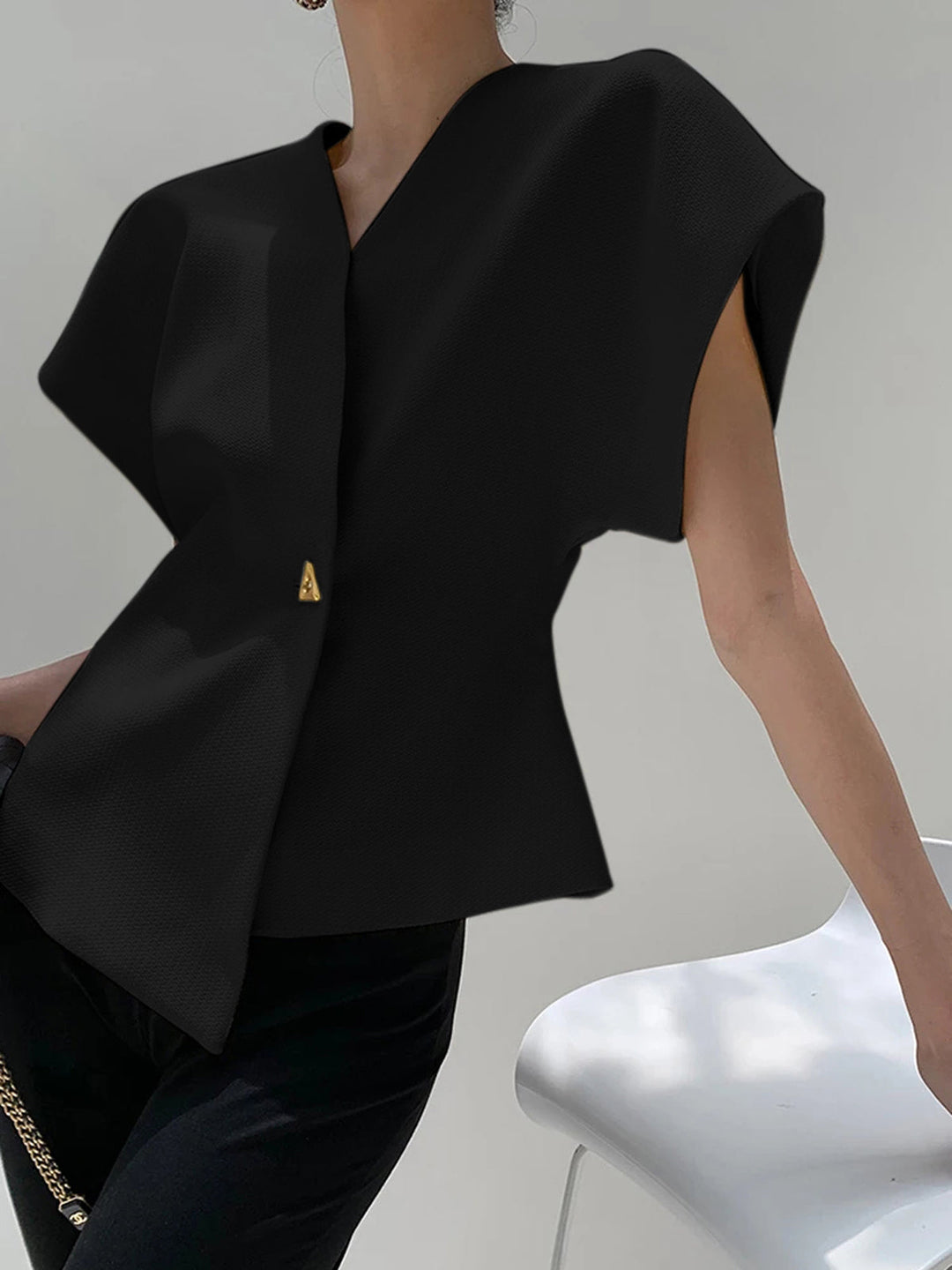 "Elegant women's V-neck blouse with buttons, tailored fit, chic button-down design, ideal for versatile stylish outfits."