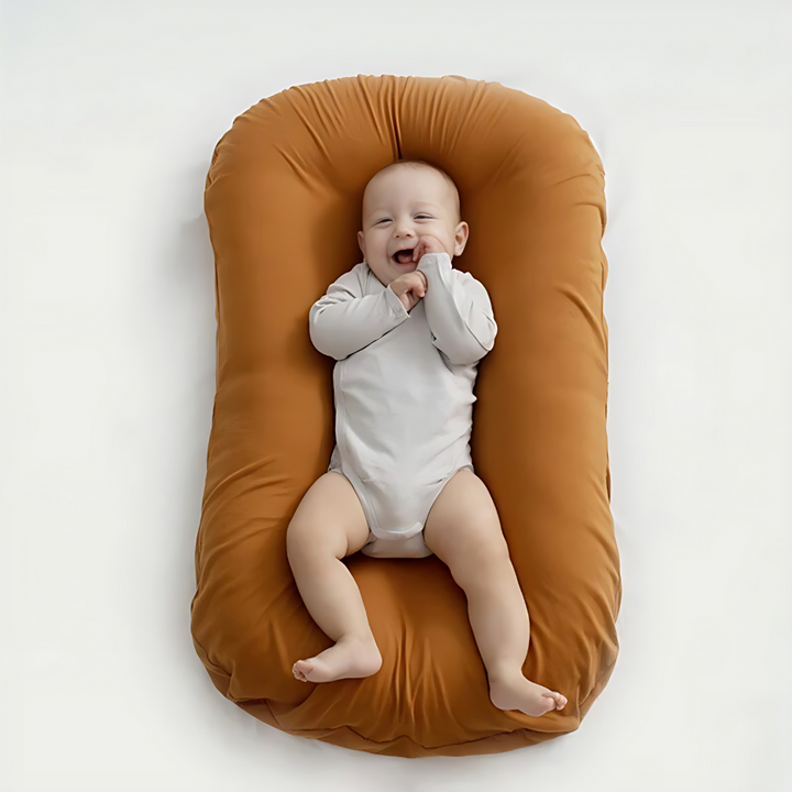Ergonomic Breathable Baby Pillow in pink, green, and brown; hypoallergenic, provides head support, prevents flat head.