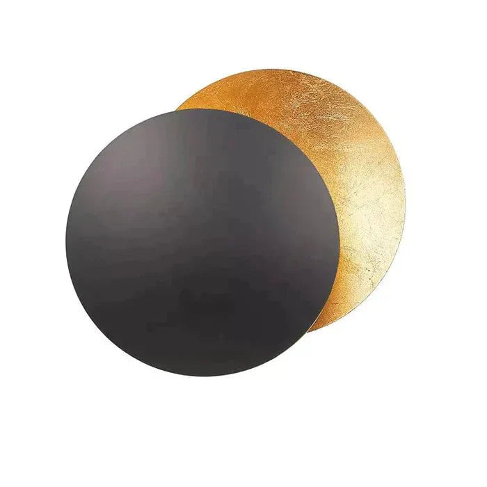 "Golden Solaris Wall Lamp with eclipse-inspired design, featuring elegant gold discs and warm LED glow for home decor."