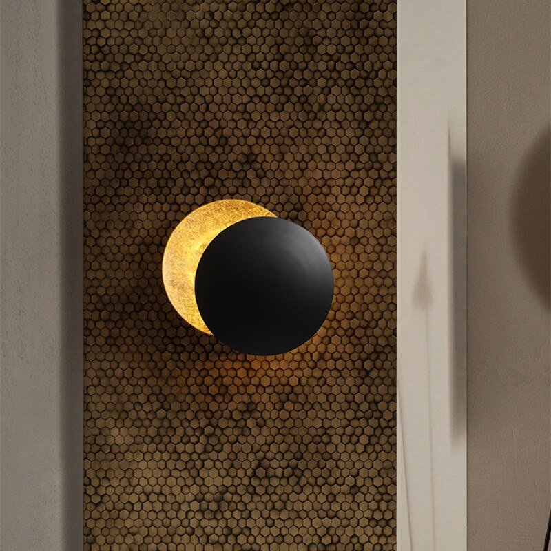 "Golden Solaris Wall Lamp with eclipse-inspired design, featuring elegant gold discs and warm LED glow for home decor."