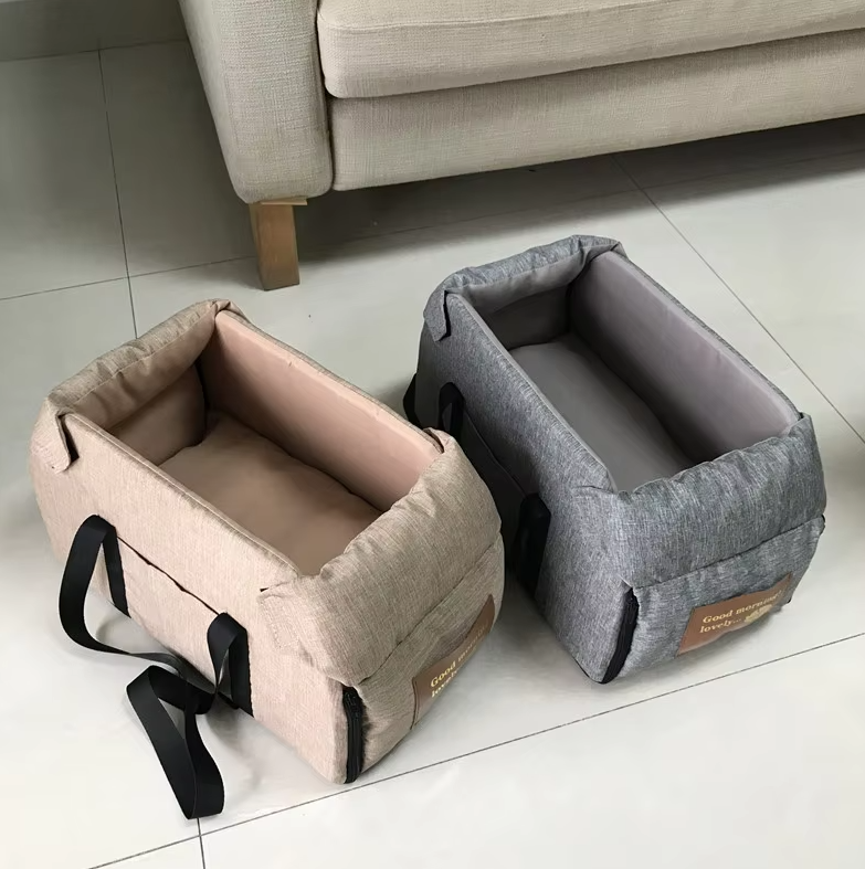 "Luxe padded dog car seat with safety belt, portable for travel, ensuring comfort and security during car journeys."