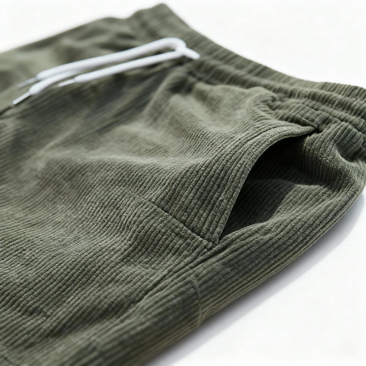 Men's casual swim shorts with elastic waistband, above-the-knee length, side pockets, and drawstring for adjustable fit.