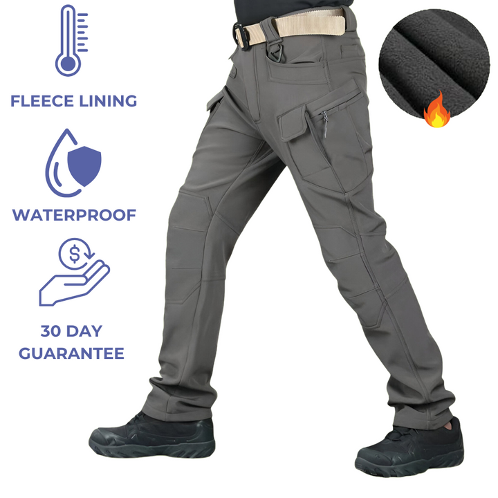 Men's waterproof fleece-lined tactical trousers with ten pockets, reinforced knees, shown outdoors for extreme weather use.