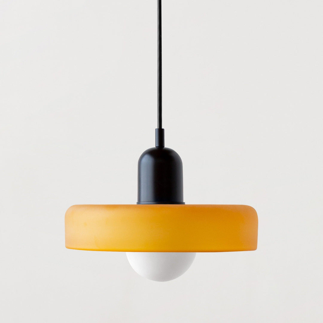 "Modern glass pendant light with sleek glass, brushed metal, ideal for elegant interiors, adds sophistication and warmth."