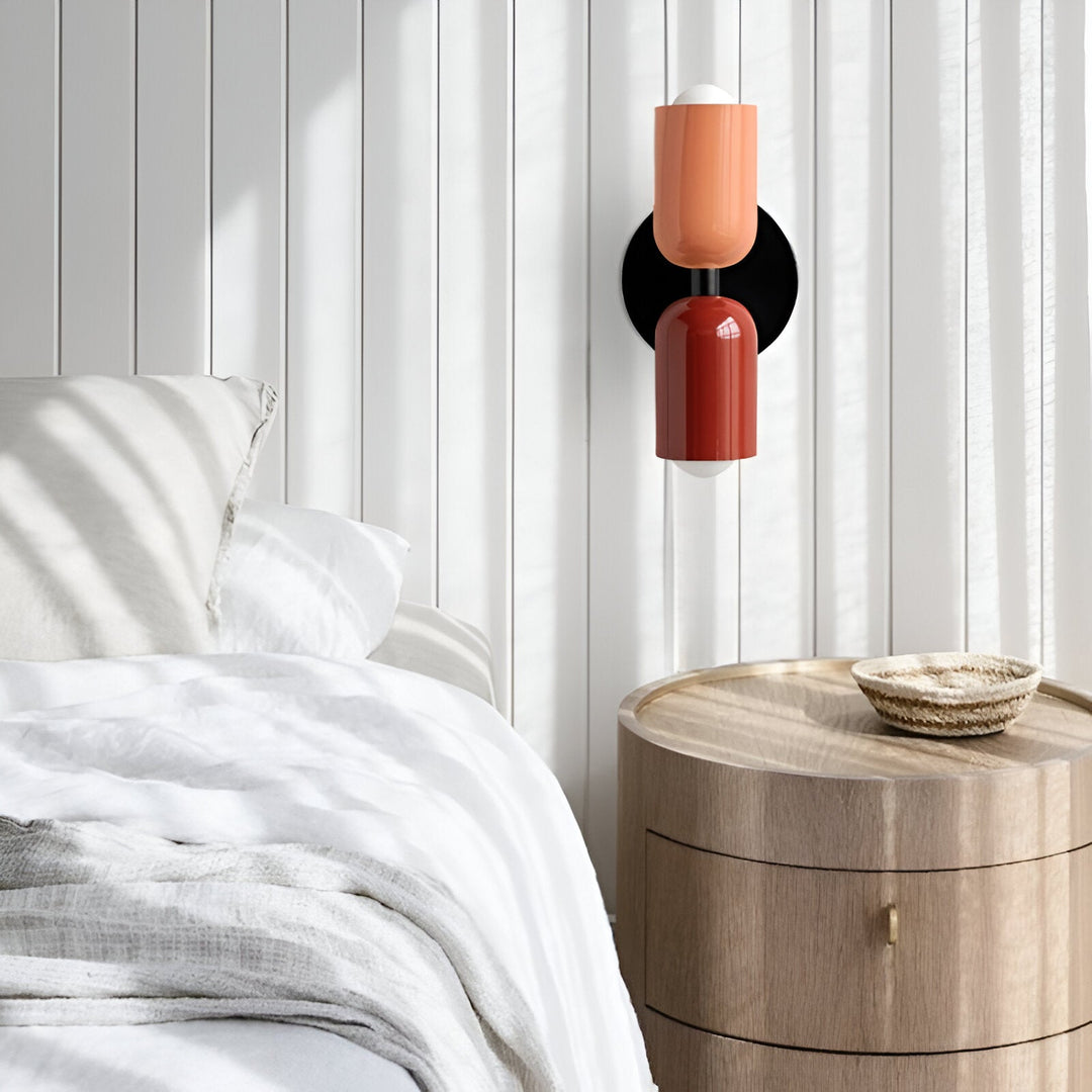 Nordic colourful double head wall light in vibrant colors, painted iron, sleek cylindrical design, casts light up and down.