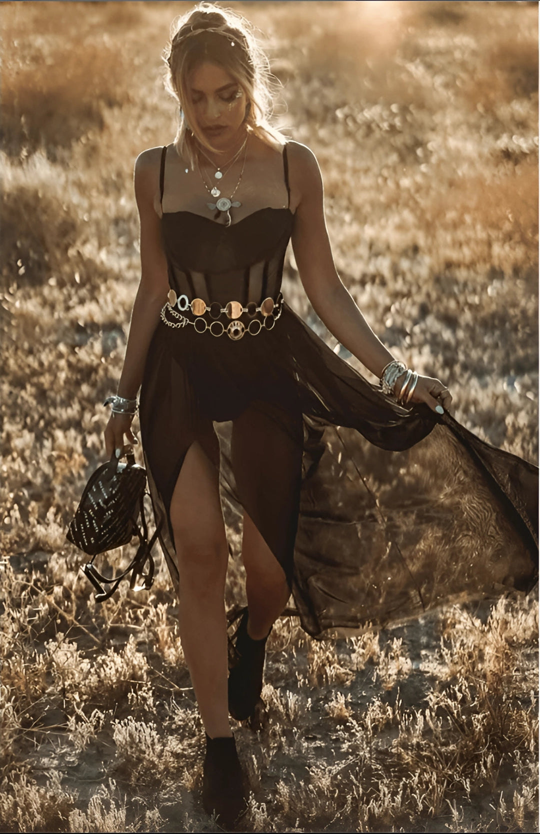 Sheer black strapless bohemian dress for women. Flowy, elegant fabric enhances silhouette. Ideal for chic, stylish events.