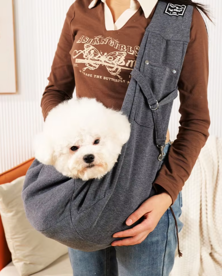"Stylish pet carrier bag with padded strap for small dogs and cats, featuring breathable, lightweight design for travel comfo