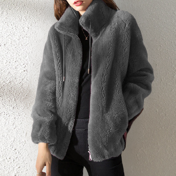 "Stylish women's warm jacket, grey, zip closure, premium polyester, elegant design, versatile fit for the chilly season."