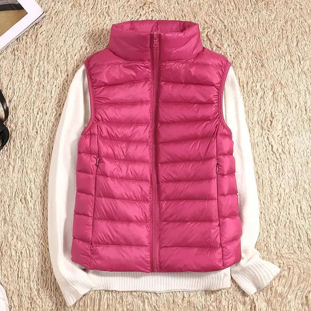 "Ultra-light women's autumn down vest in sleek fit, available in Black, Blue, Khaki; stylish and packable for cool days."