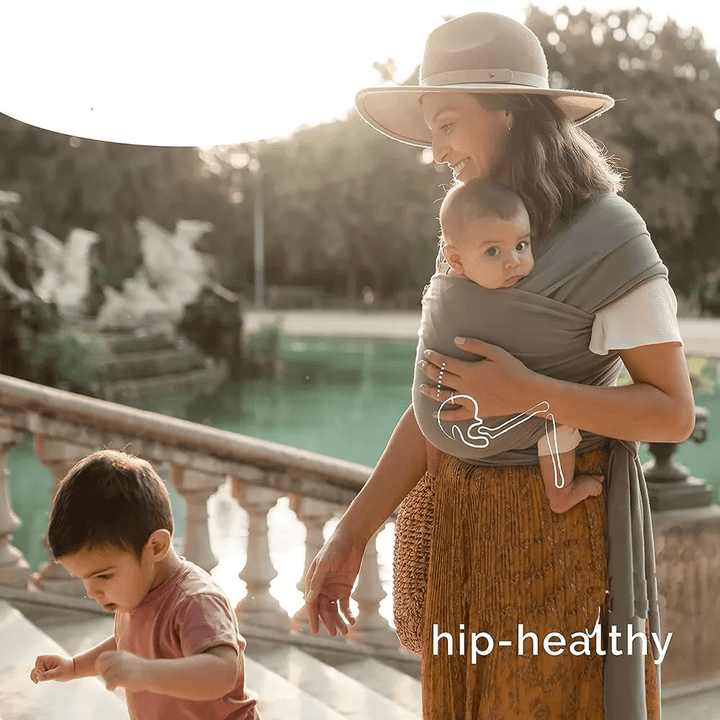"Unisex ergonomic baby wrap carrier, grey, enveloping baby and parent comfortably for hands-free convenience."