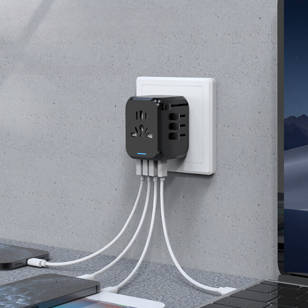 "Universal travel adapter, compact black design, with USB ports and global plug compatibility for 150+ countries."