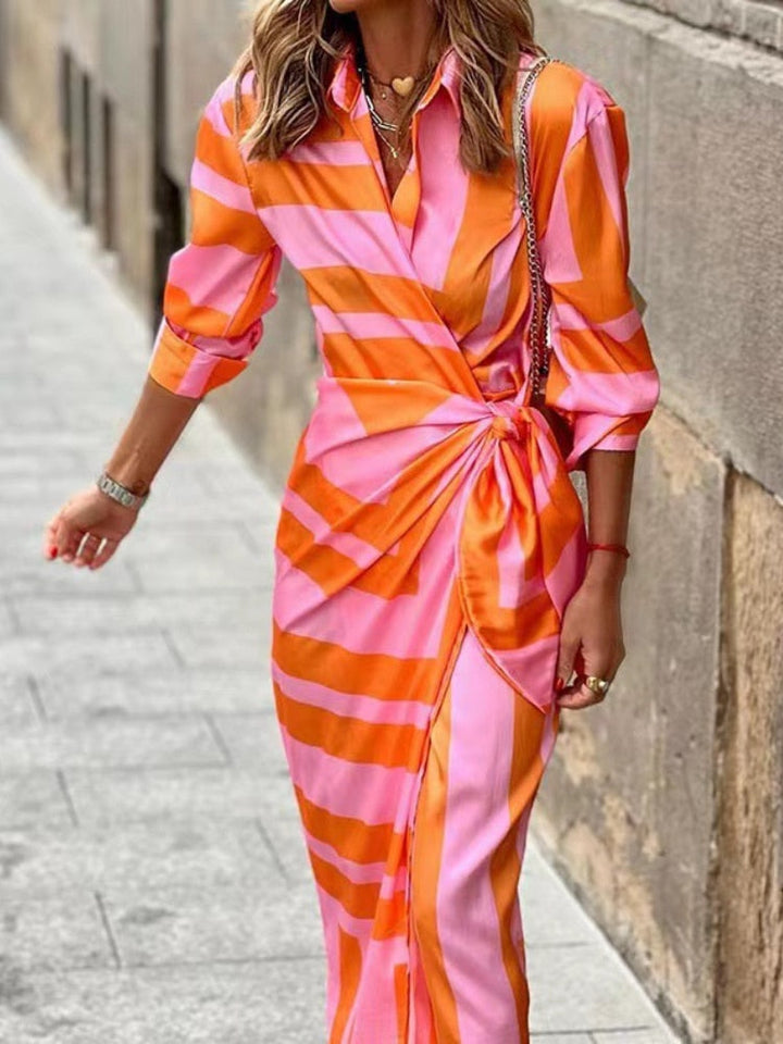 Vibrant women's summer dress with bold, multicolored design and flattering silhouette, perfect for casual outings.