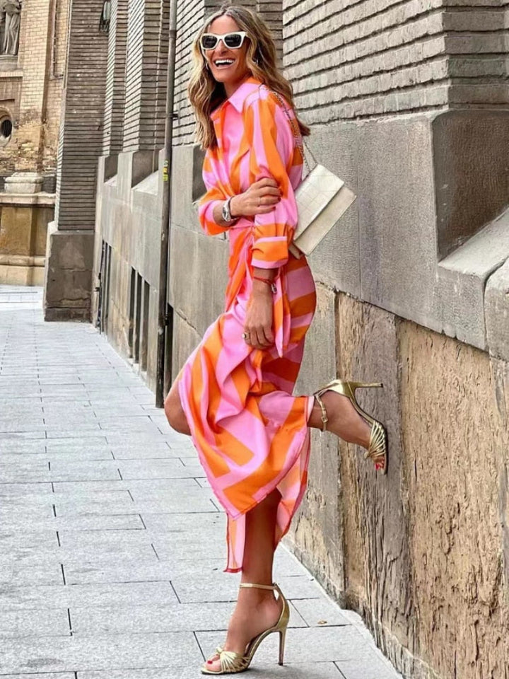 Vibrant women's summer dress with bold, multicolored design and flattering silhouette, perfect for casual outings.