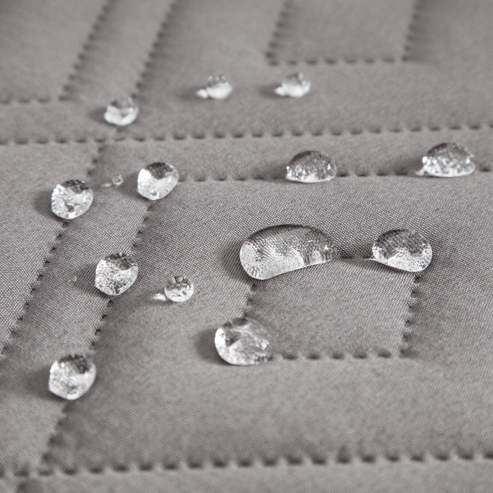 "Water-repellent non-slip reversible sofa cover protecting couch from spills and stains with pet sitting on it"
