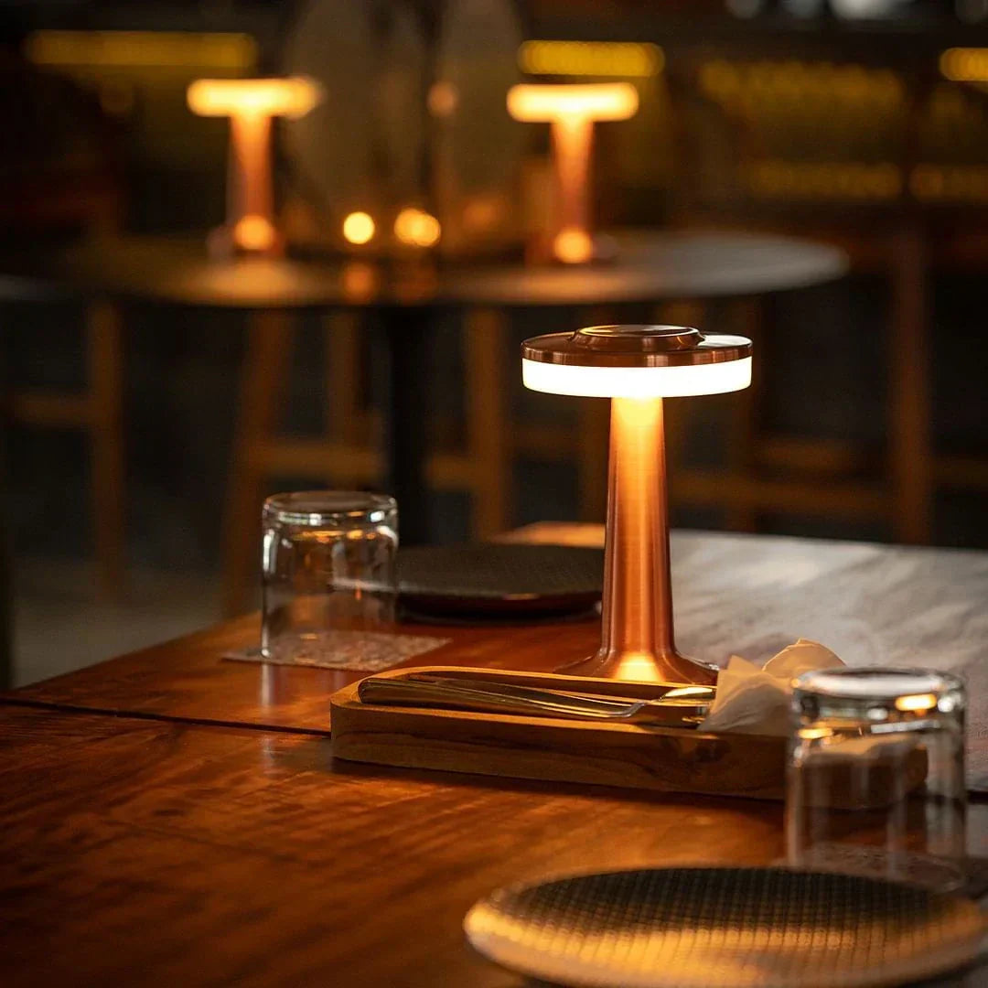 "Wireless retro table lamp with luxurious metallic finish, dimmable LED light, versatile cordless design for any setting."