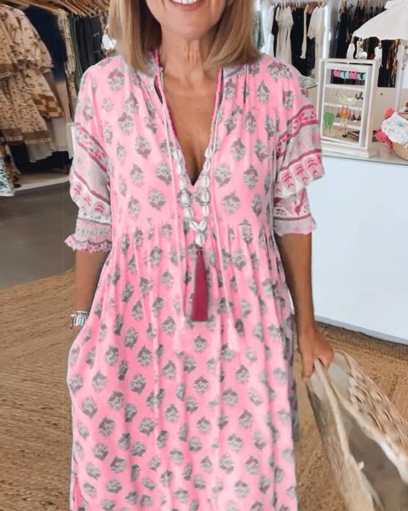 Women's V-Neck Half-Sleeve Dress with bold print, vibrant colors; casual or evening wear, enhances elegance and comfort.