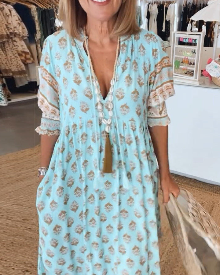 Women's V-Neck Half-Sleeve Dress with bold print, vibrant colors; casual or evening wear, enhances elegance and comfort.