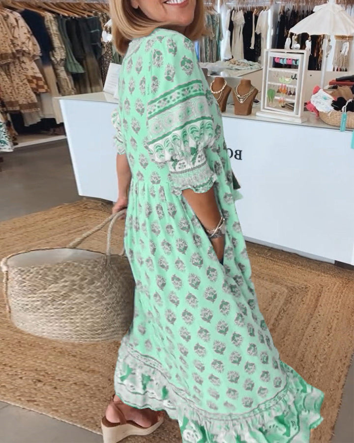 Women's V-Neck Half-Sleeve Dress with bold print, vibrant colors; casual or evening wear, enhances elegance and comfort.