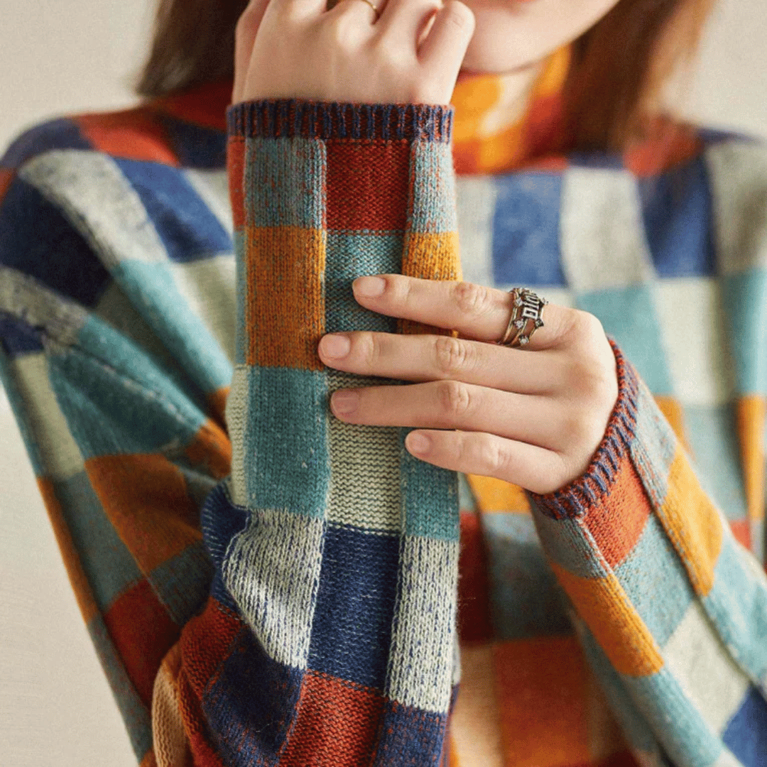 Women's cashmere patchwork turtleneck sweater in mélange hues, showcasing a unique, cozy, and stylish design for winter.