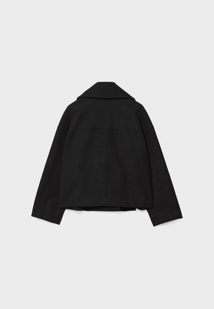 Women's double-breasted cropped jacket, front view featuring sharp lapels, structured design, and chic oversized buttons.