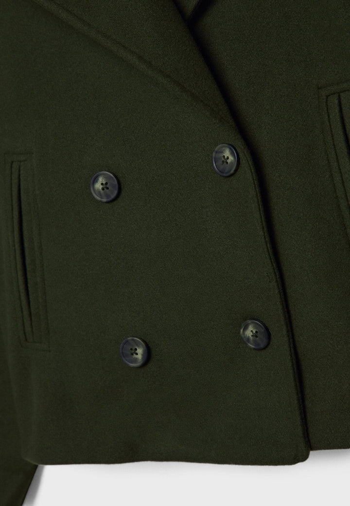 Women's double-breasted cropped jacket, front view featuring sharp lapels, structured design, and chic oversized buttons.