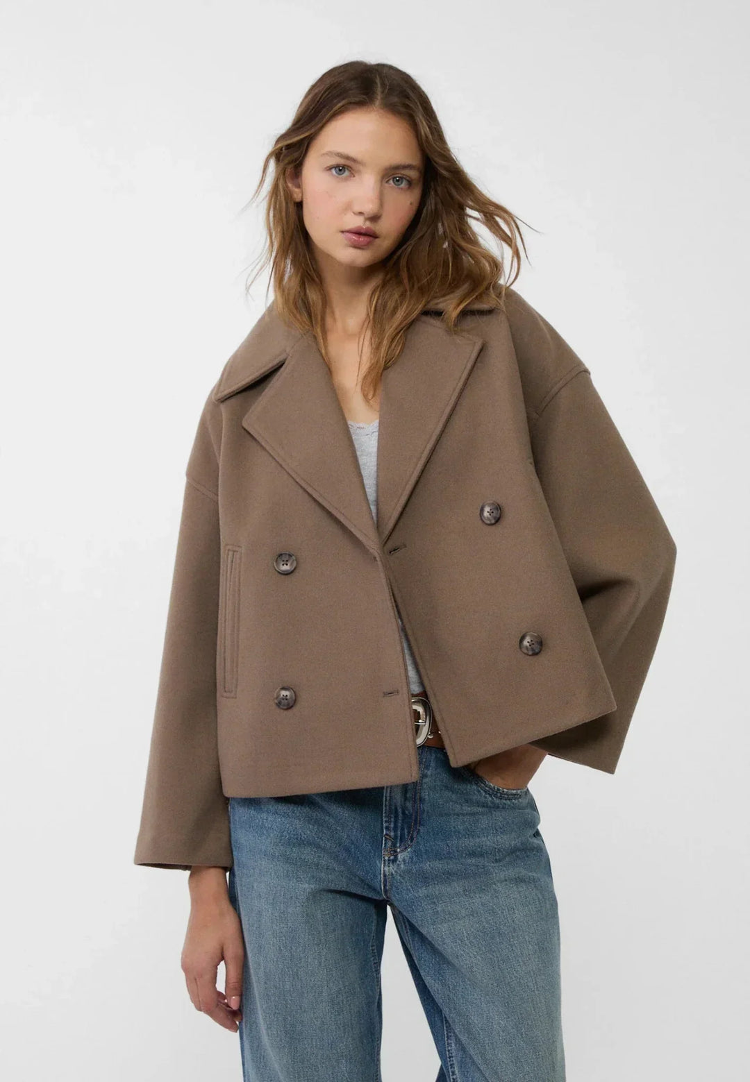 Women's double-breasted cropped jacket, front view featuring sharp lapels, structured design, and chic oversized buttons.
