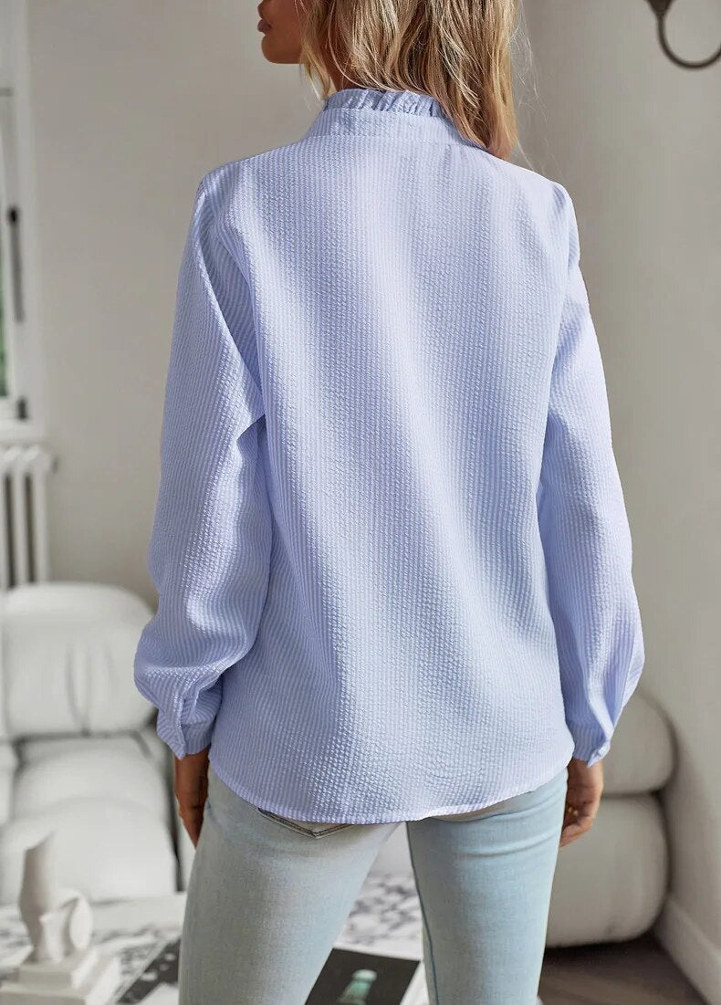 "Women's luxurious polo blouse, soft fabric with a classic button placket and tailored hem, perfect for elegant daily wear."