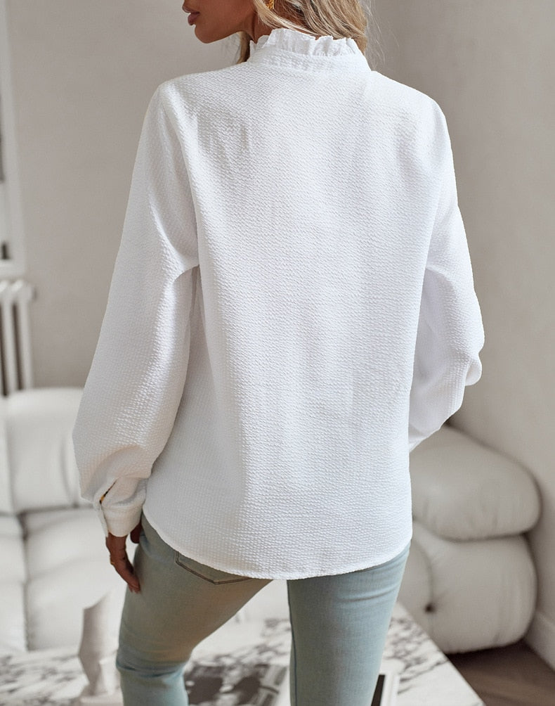 "Women's luxurious polo blouse, soft fabric with a classic button placket and tailored hem, perfect for elegant daily wear."