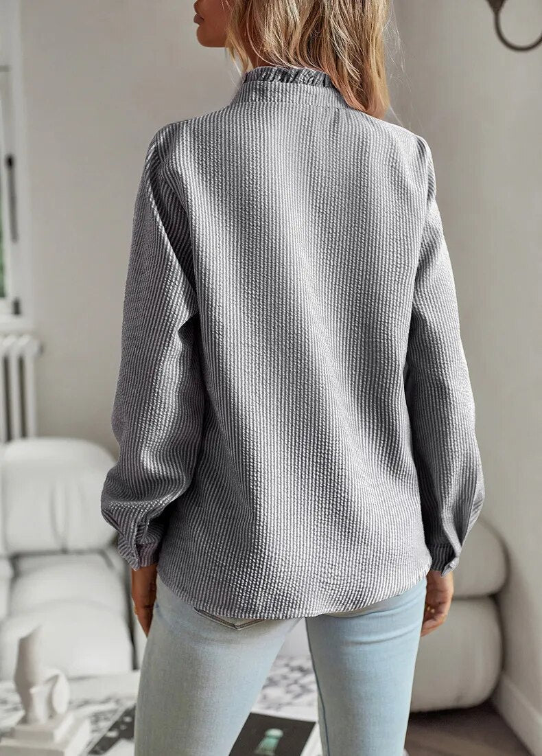 "Women's luxurious polo blouse, soft fabric with a classic button placket and tailored hem, perfect for elegant daily wear."