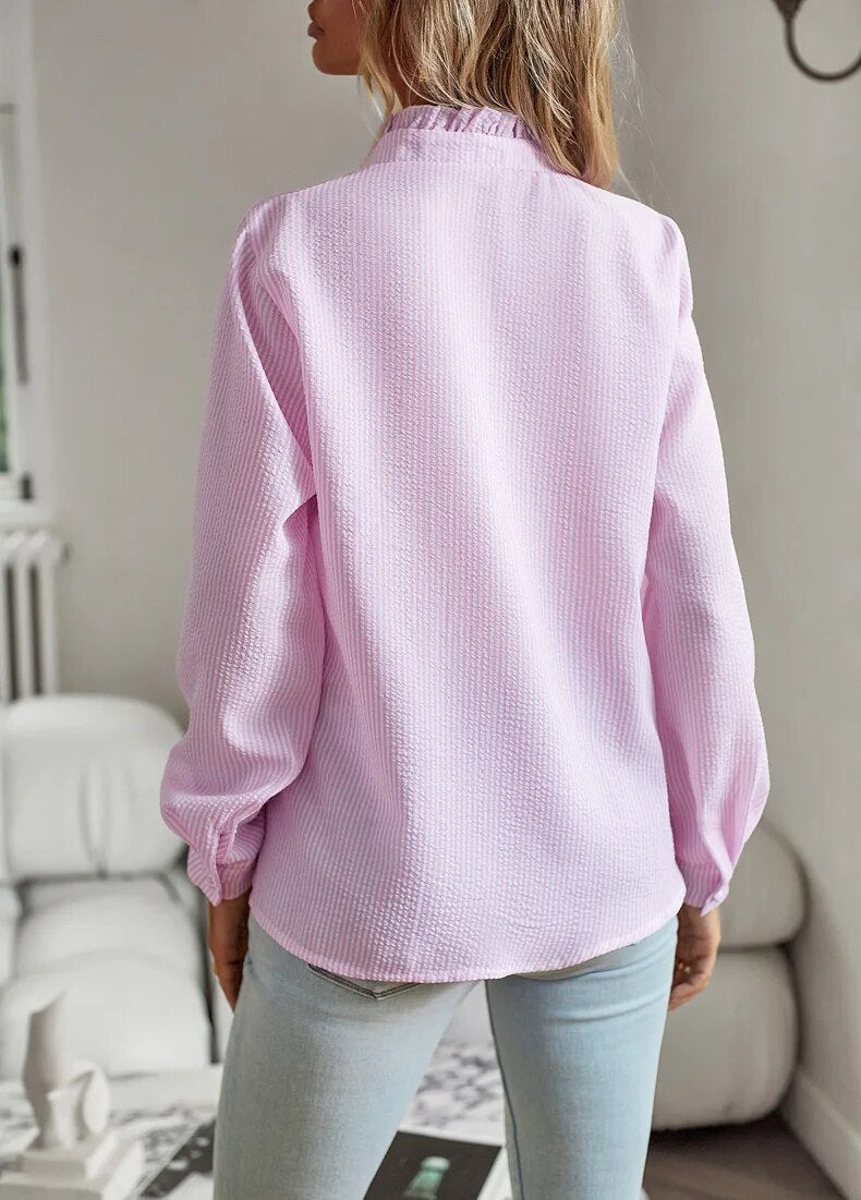 "Women's luxurious polo blouse, soft fabric with a classic button placket and tailored hem, perfect for elegant daily wear."