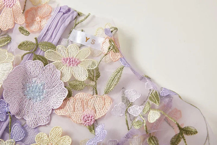 "Women's sheer embroidered maxi dress, elegant and flowing, in various colors; lightweight fabric for special occasions."