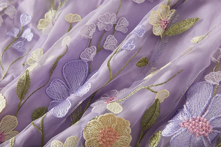 "Women's sheer embroidered maxi dress, elegant and flowing, in various colors; lightweight fabric for special occasions."