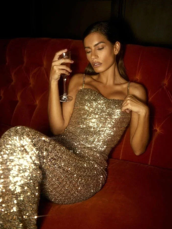 "Women's strapless glitter jumpsuit with waist belt, sparkling fabric, figure-hugging fit, ideal for evening events and parti