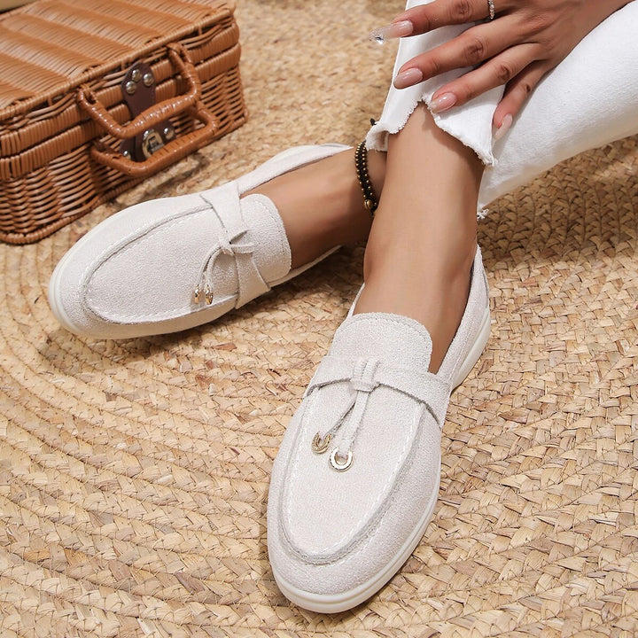 Women's suede finish loafers in white, offering comfort and style. Perfect casual shoes for elegance and ease.