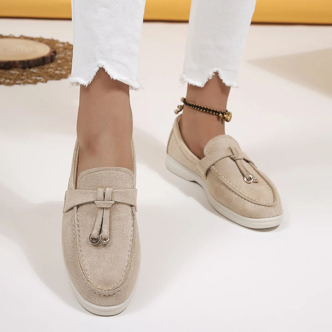 Women's suede finish loafers in white, offering comfort and style. Perfect casual shoes for elegance and ease.