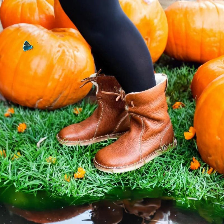 "Women's winter boots, waterproof leather with wool lining, offering style and warmth for cold weather conditions."