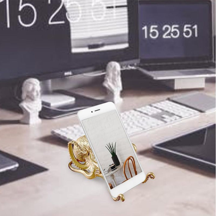 Whimsical brass octopus, serving as a phone stand and charming desk novelty