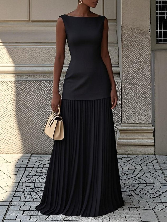 Women's sleeveless pleated maxi dress featuring a chic boat neck & drop waist. Ideal formal wedding guest attire.