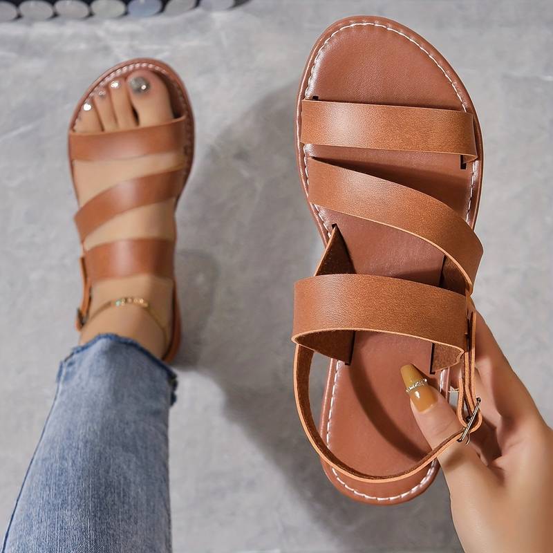 Stylish women's flat three-strap sandals with open toe, offering comfort for summer and everyday wear.