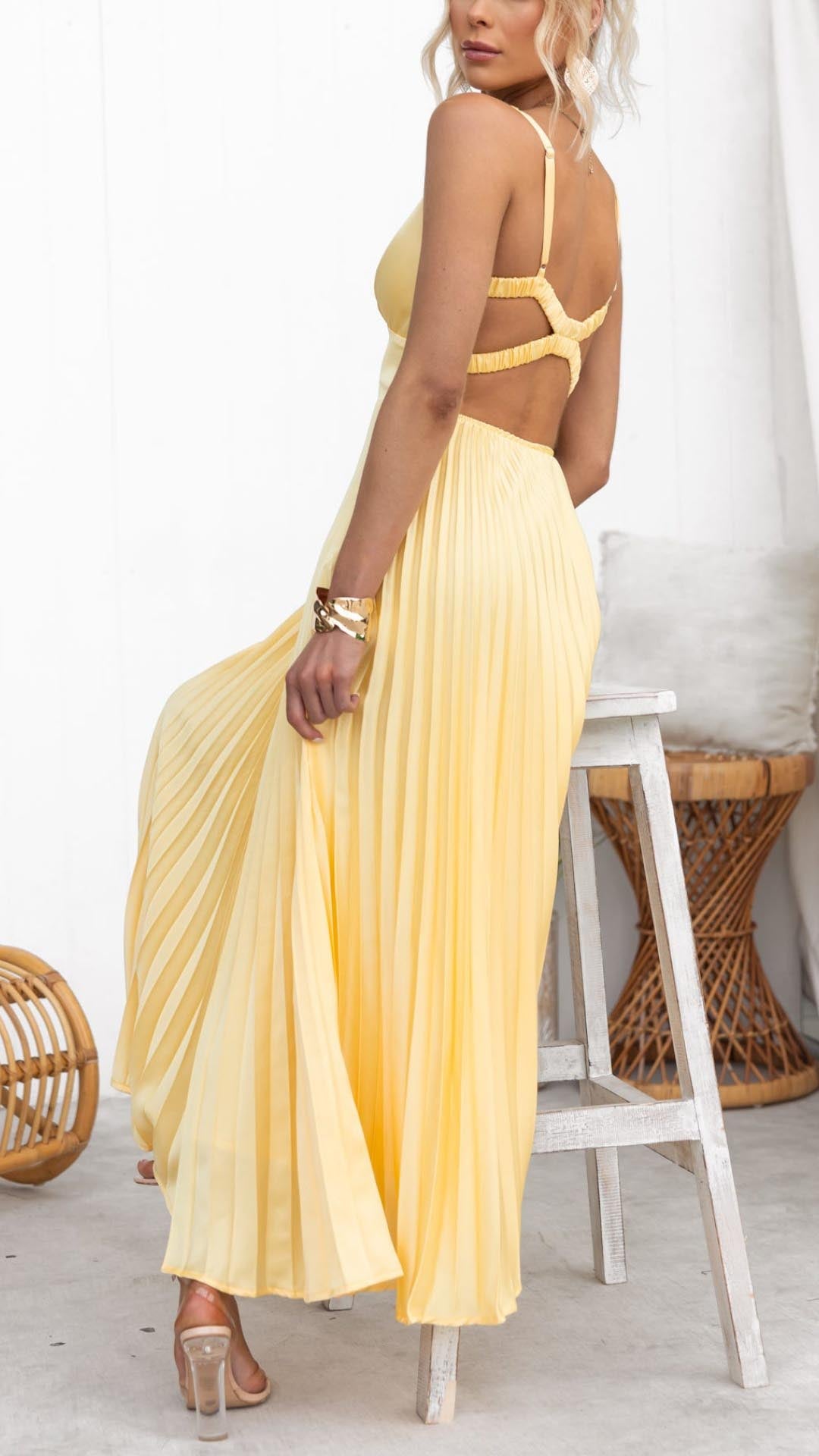 Yellow V-neck midi wedding guest dress with elegant pleats, a chic A-line silhouette for women's summer occasions.