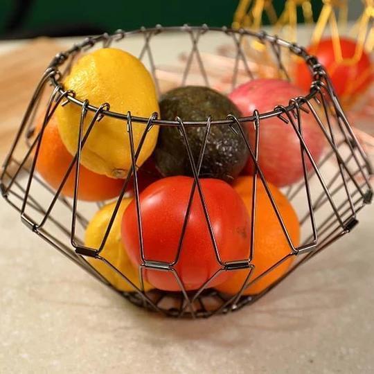 Modern rose gold collapsible stainless steel fruit bowl, functional and decorative kitchen storage.
